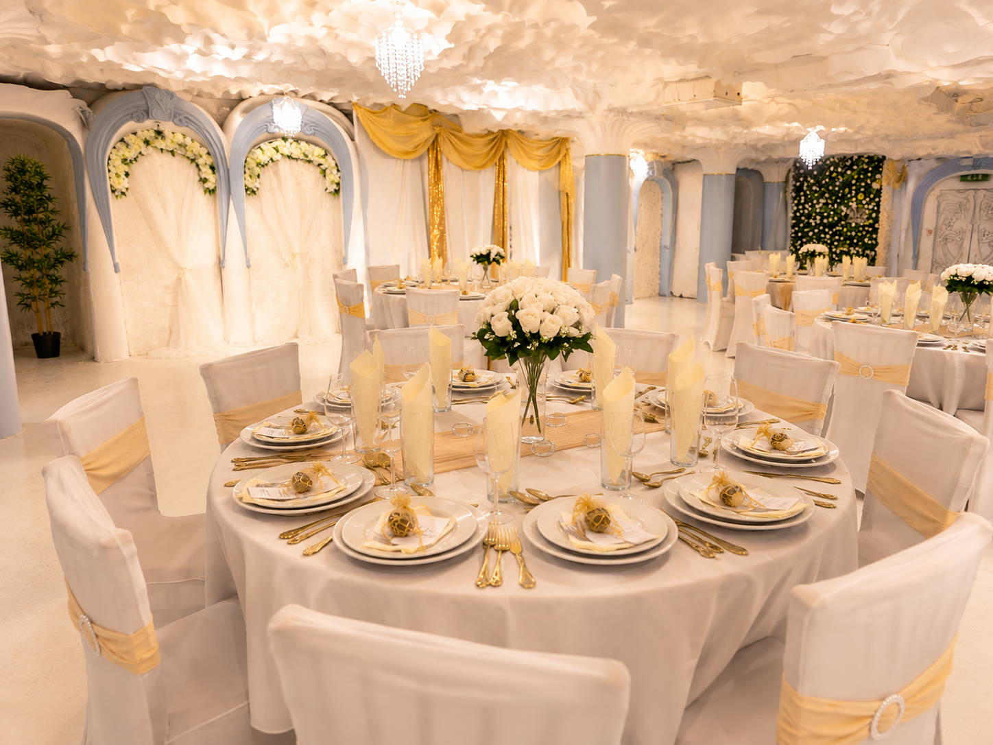 Asian wedding setup at Opulent @ 35 Liverpool — pale blue Art Nouveau arches with white floral walls and gold drapery for a Nikah and Walima